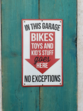 Metal sign -  "IN THIS GARAGE - BIKES TOYS AND KIDS STUFF goes HERE - NO EXCEPTIONS"