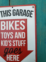 Metal sign -  "IN THIS GARAGE - BIKES TOYS AND KIDS STUFF goes HERE - NO EXCEPTIONS"