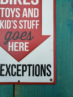 Metal sign -  "IN THIS GARAGE - BIKES TOYS AND KIDS STUFF goes HERE - NO EXCEPTIONS"